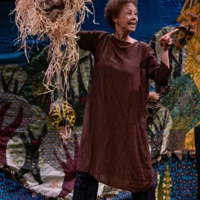 A woman with a puppet made of straw